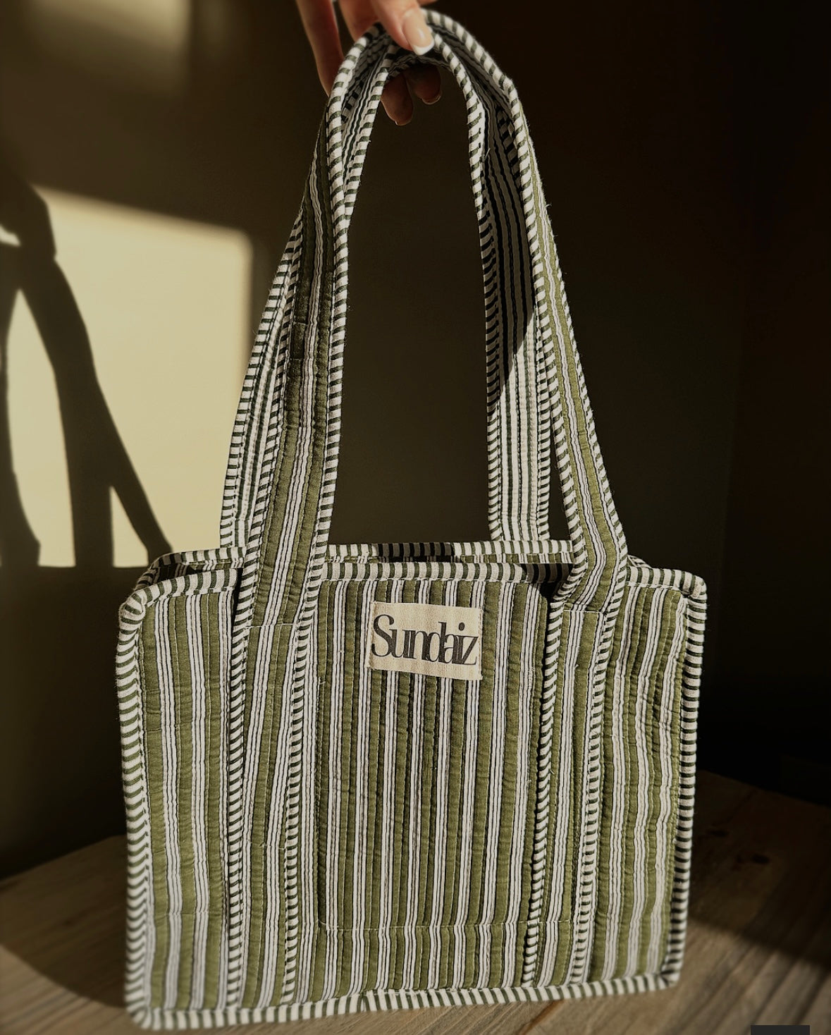 Olive stripe bags.