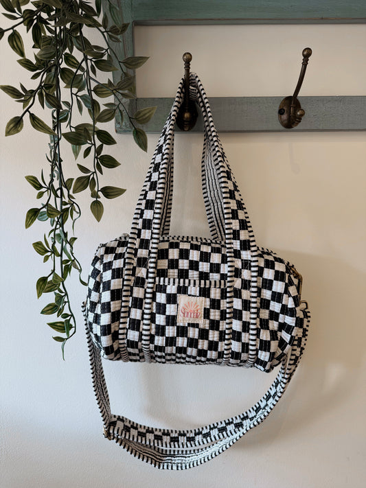 Black chequerboard mini duffle.