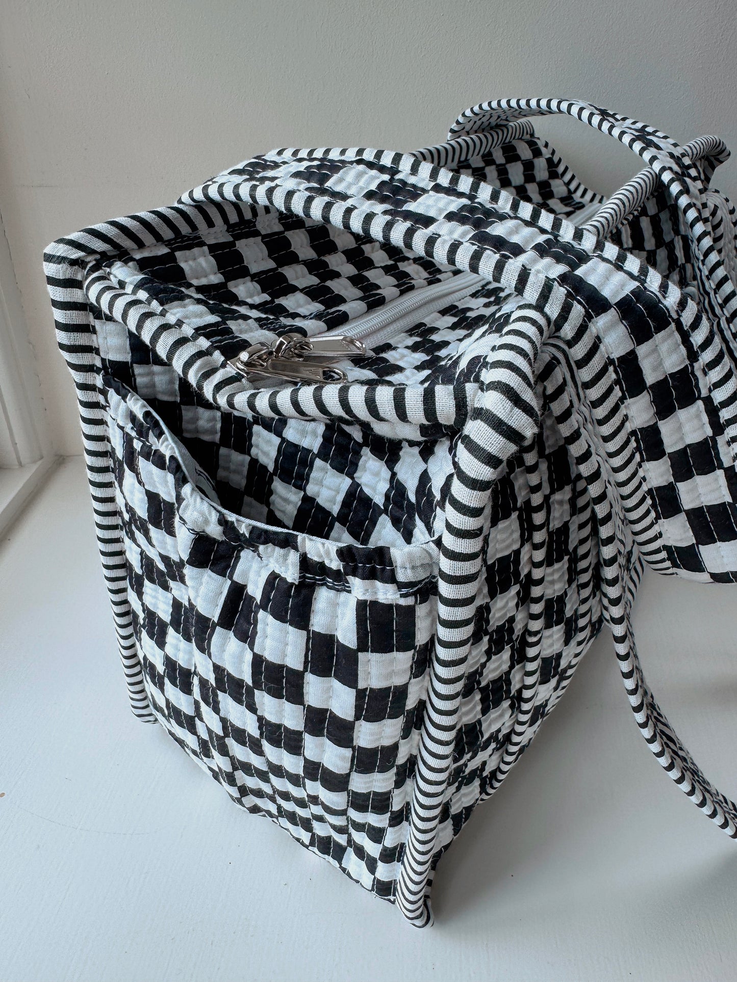 Black chequerboard midi tote.